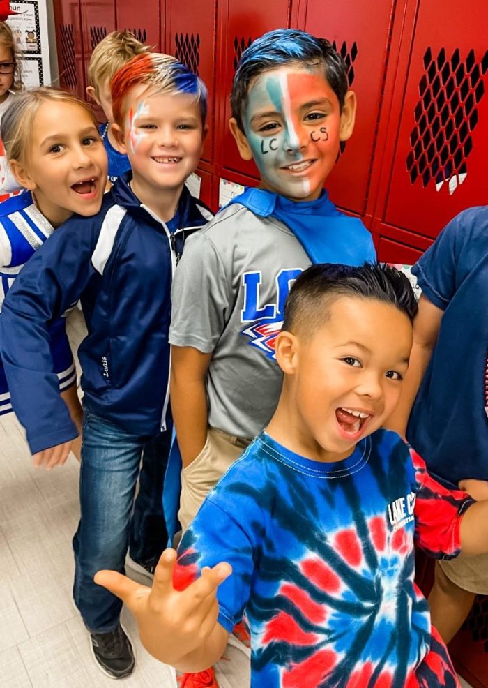 students with spirit gear and painted faces and hair for super spirit day